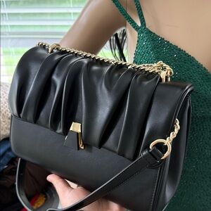 Elegant Black Leather Handbag with Gold Accents